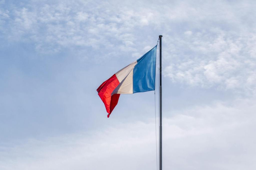 french national flag waving against a clear sky